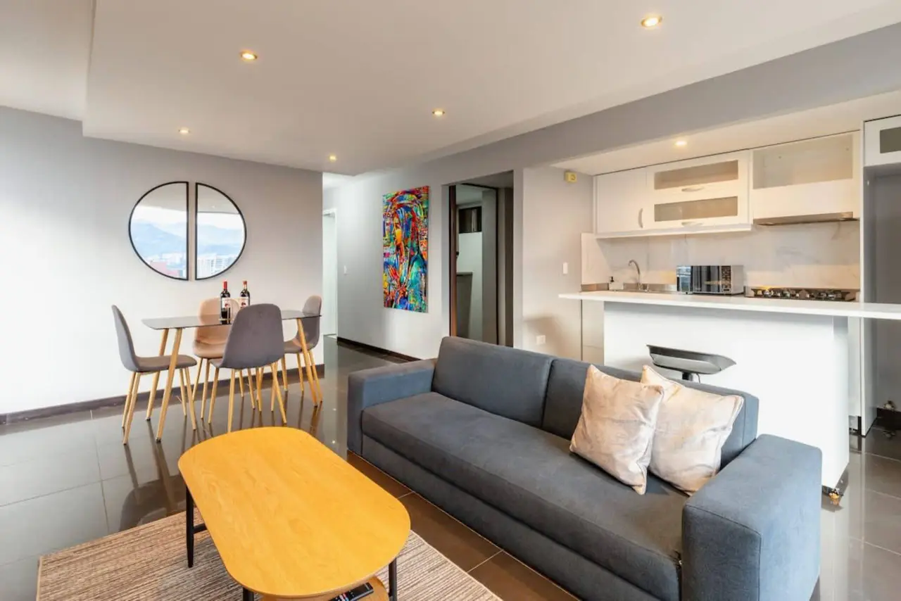 Sofa, coffee table and the kitchen's breakfast bar behind