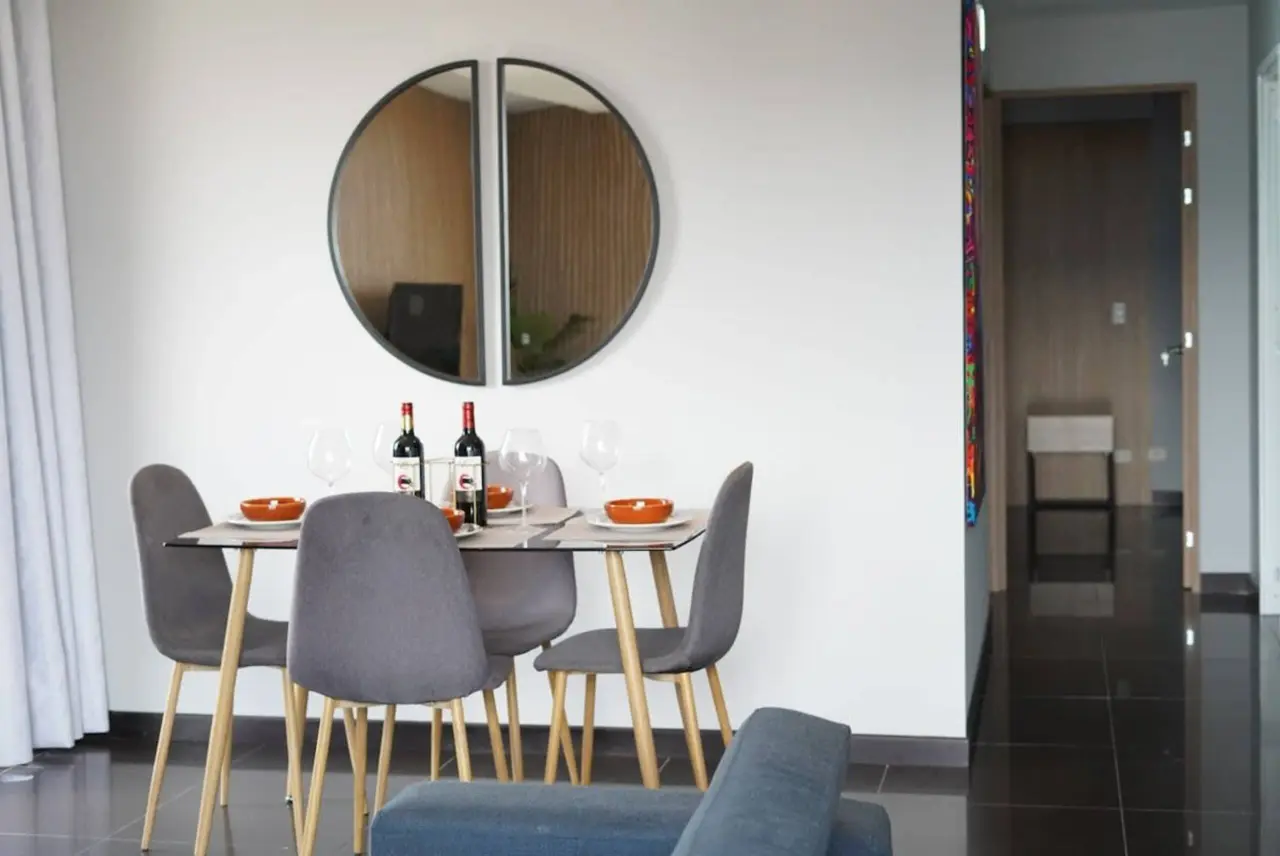 The dining table laid for four, with the kitchen behind