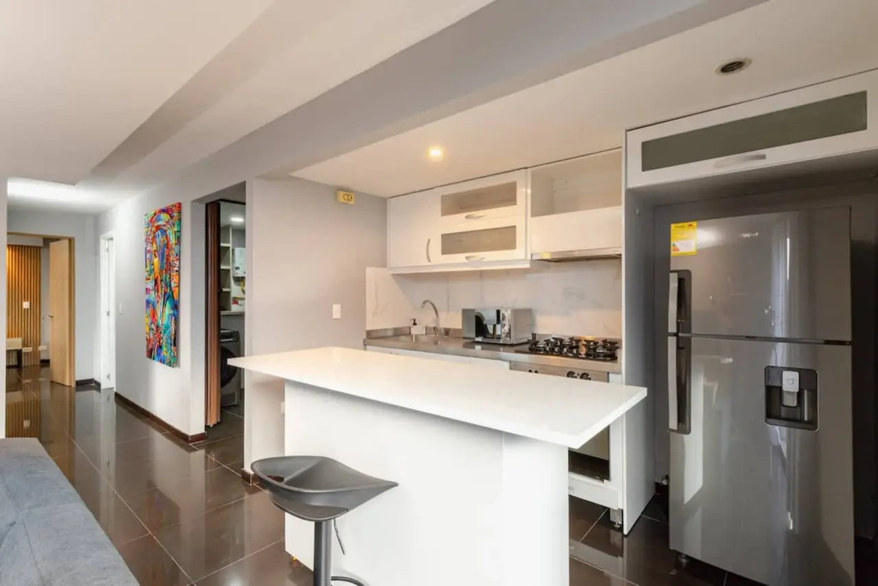 The kitchen island and breakfast bar, looking through to the hallway
