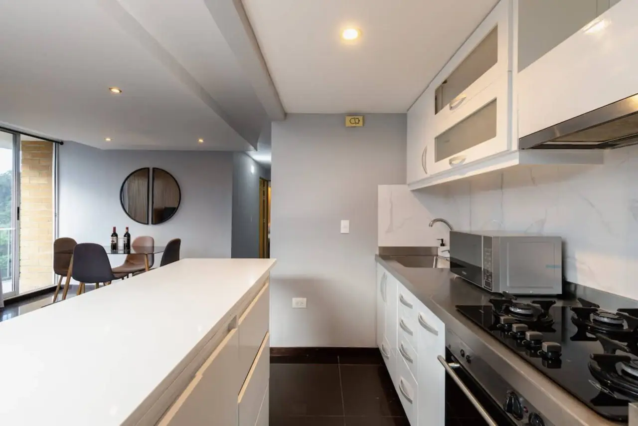 The galley kitchen, with the dining area and balcony at the end