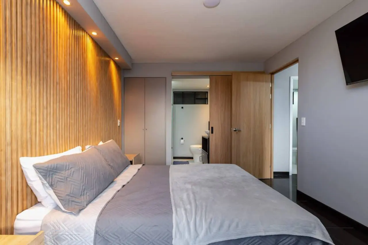 The main bedroom seen along its length, bathroom on the left