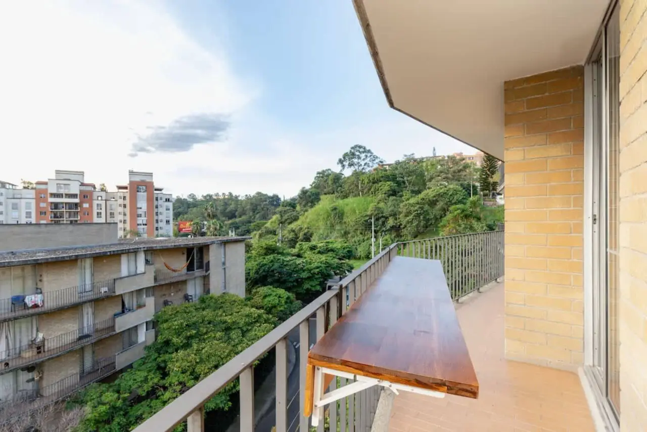 The two balconies turning the corner, over the trees and the city