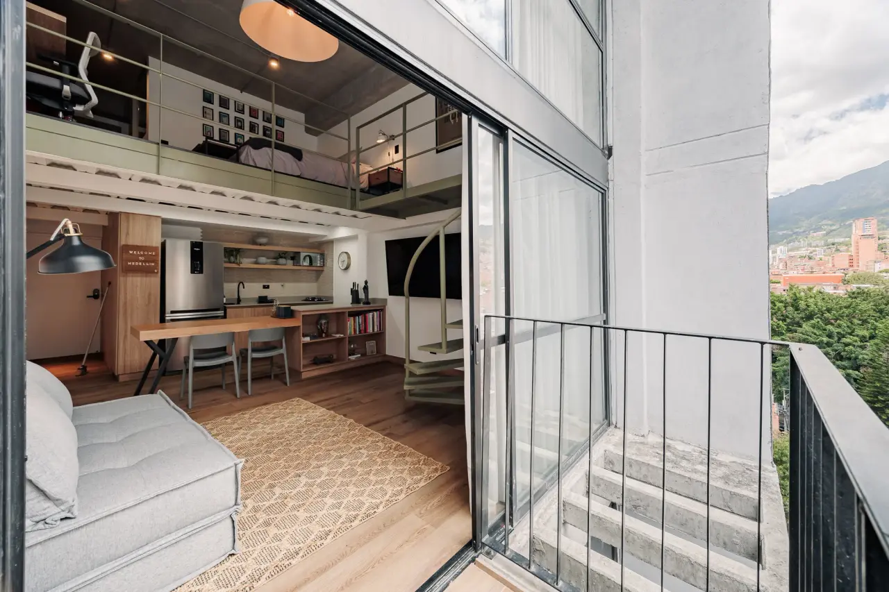 Living and dining seen from the balcony, the whole loft open to the light
