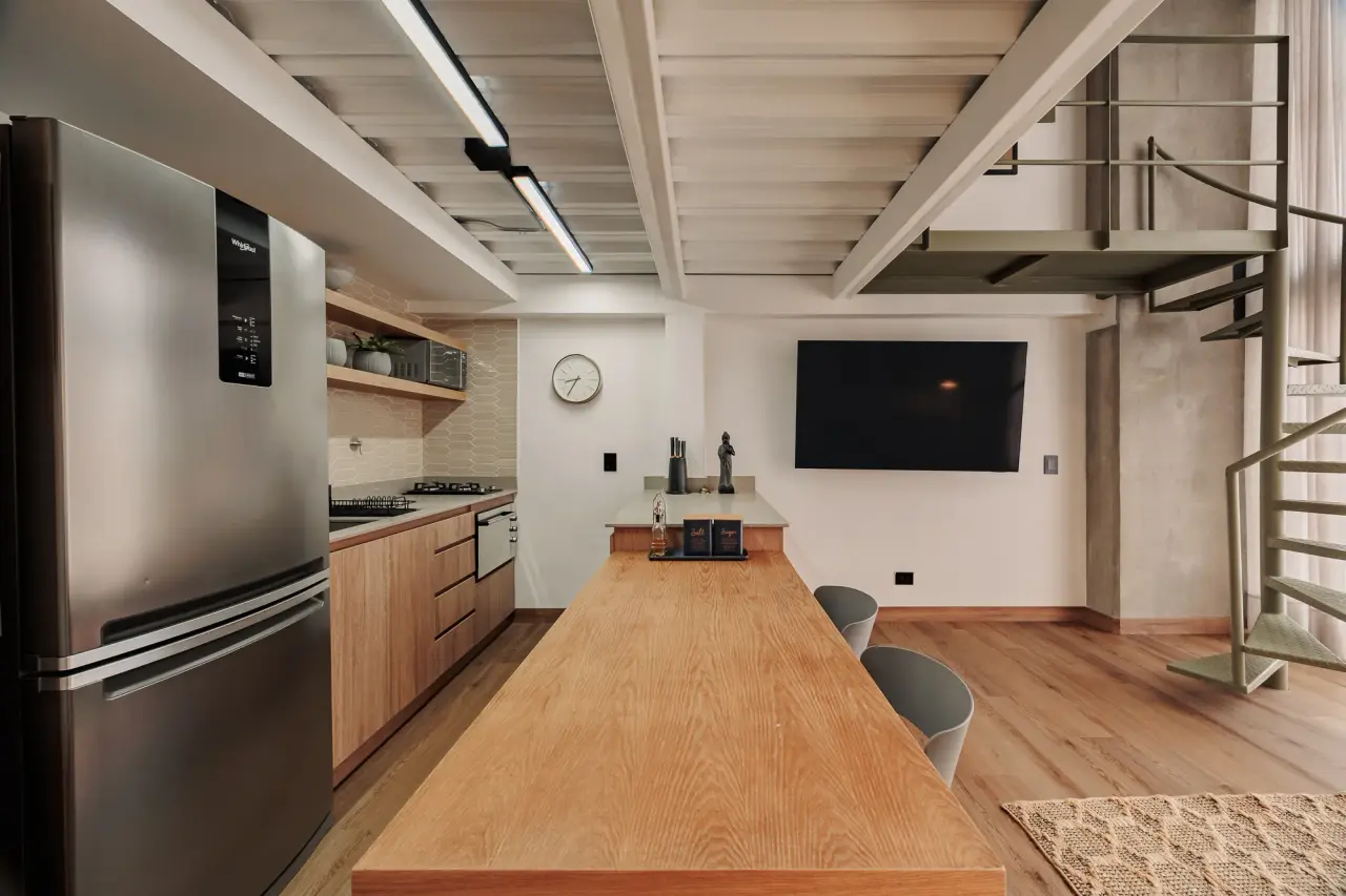 Galley kitchen with a full-height fridge, timber counter and open shelving
