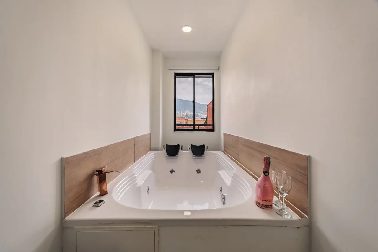 Private jacuzzi for two under the main bedroom's window, with the mountains outside