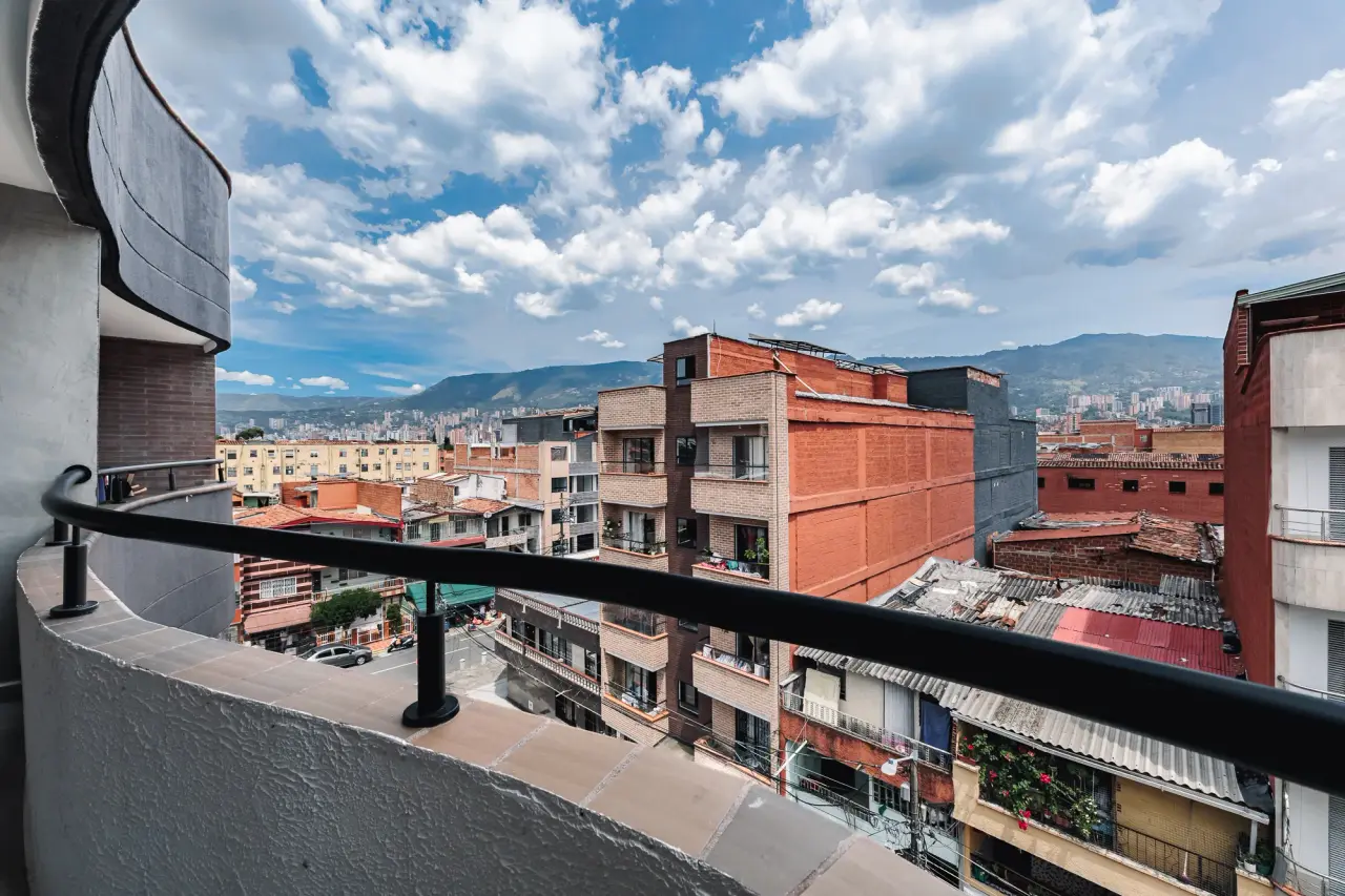 The view from the balcony across the rooftops of Itagüí to the mountains