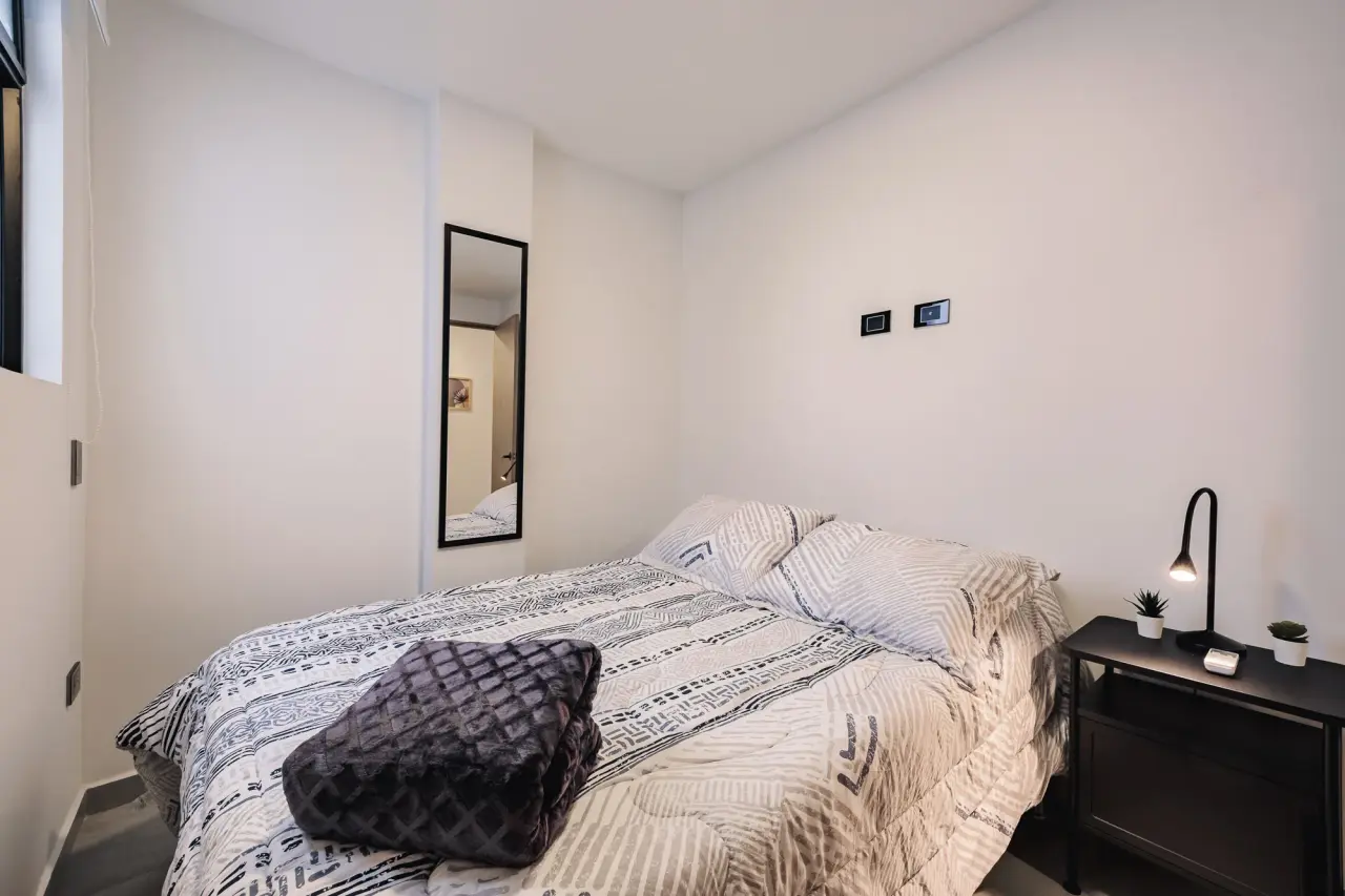 Second bedroom: bed, nightstand and reading lamp