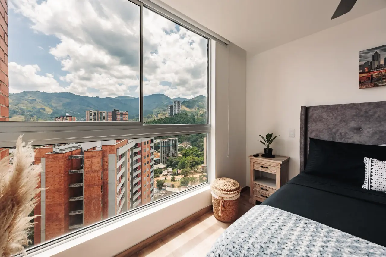Main bedroom: queen bed and the towers of Sabaneta through the corner window