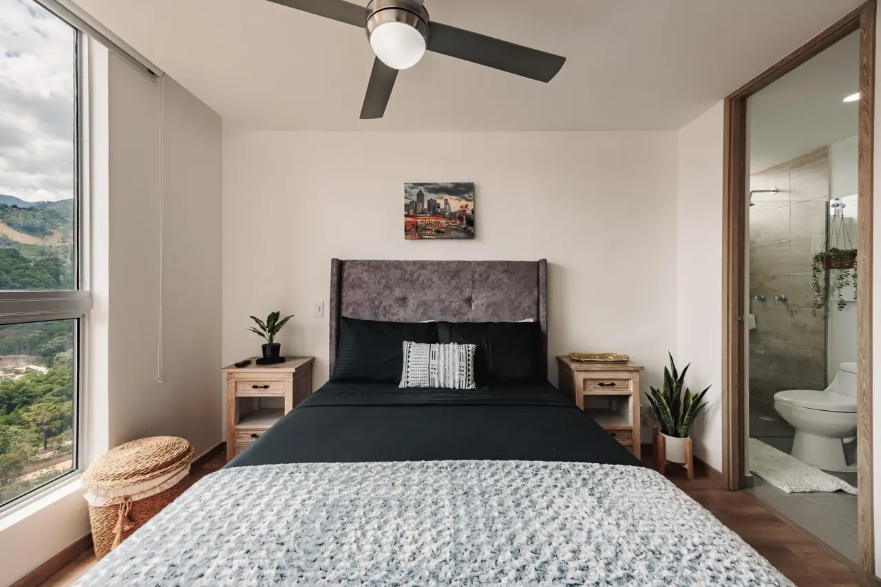 Main bedroom with the door open to its own bathroom