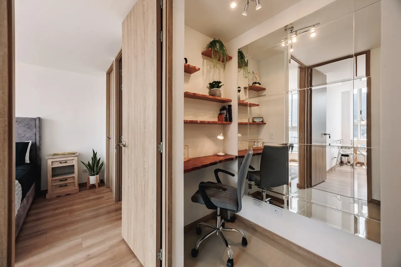 The study: desk, shelves and an office chair, next to the main bedroom