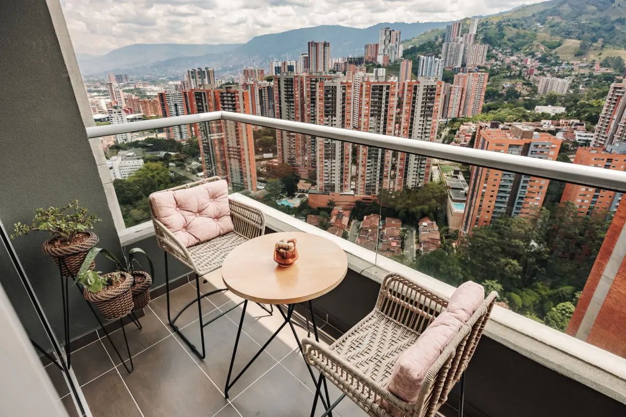 Balcony table and chairs above the brick towers of Sabaneta