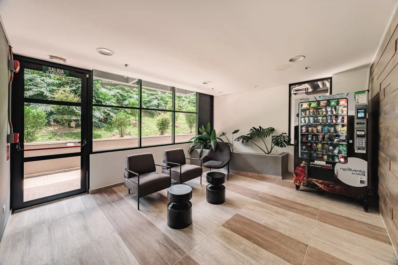 Lounge with armchairs by a glass wall to the garden